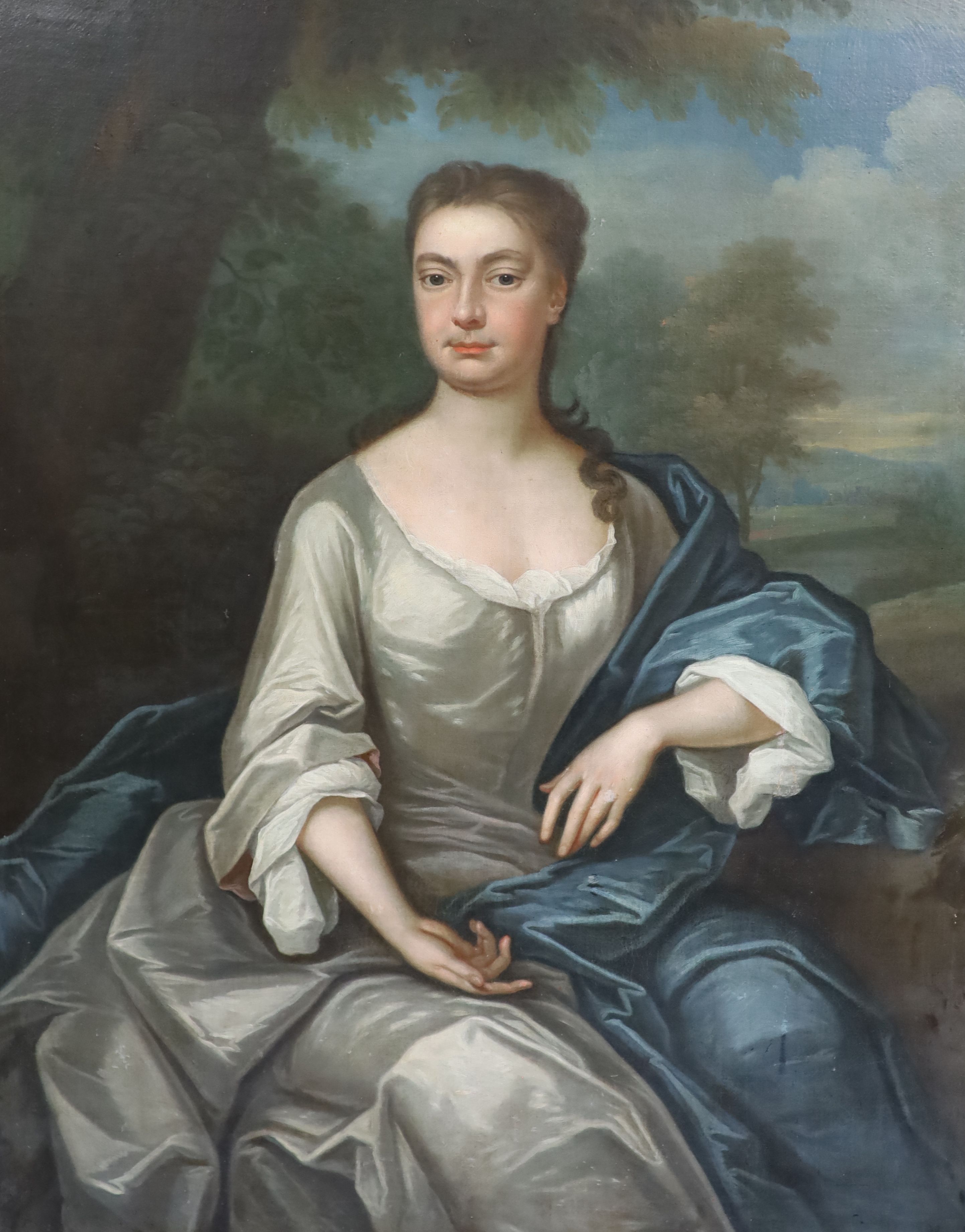 Circle of Sir Godfrey Kneller (1646-1723), Three quarter length portrait of a lady seated in a landscape, oil on canvas, 125 x 100cm